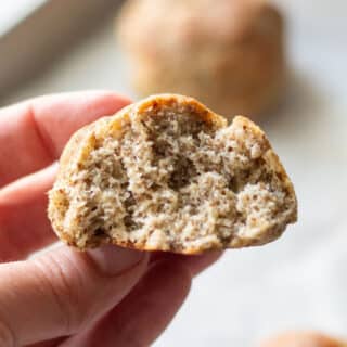 hand holding a keto roll with a bite out