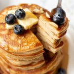 a fork taking a bite out of a stack of keto pancakes