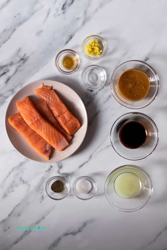 Top view photo of ingredients to make Peanut Butter Glazed Salmon in separate bowls.