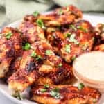 keto chicken wings on a white plate with sauce