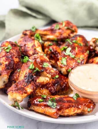 keto chicken wings on a white plate with sauce