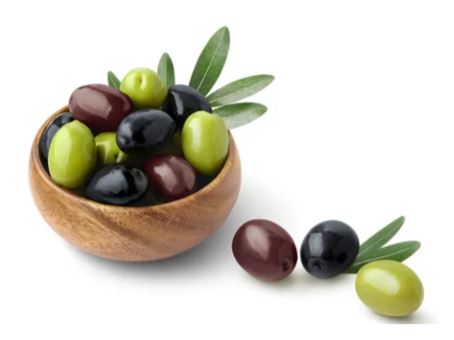 a mix of green, black and kalamata olives. Some in a bowl and some on the counter top.