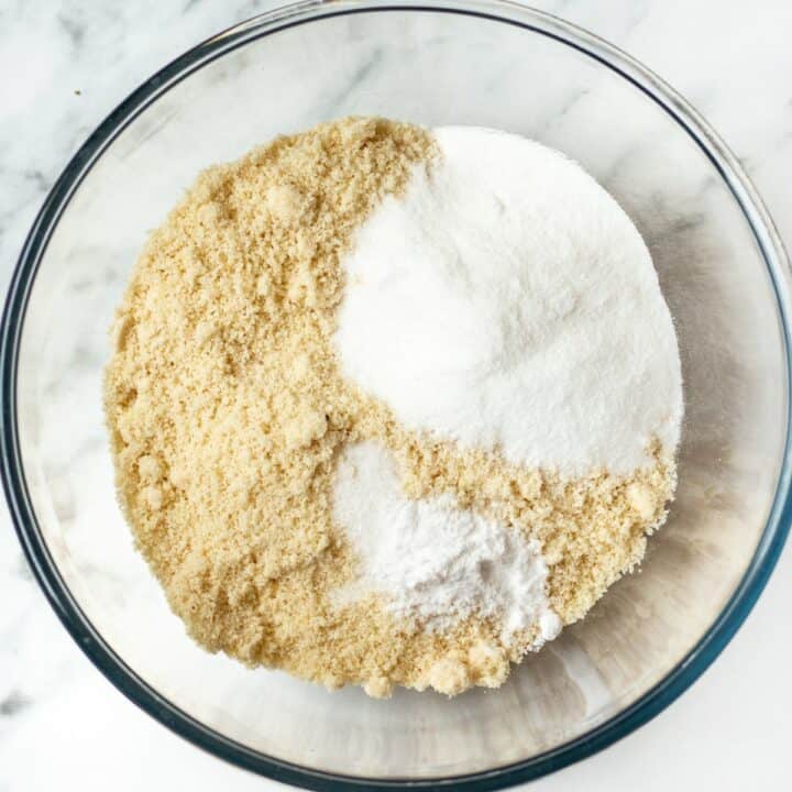 Glass bowl filled with the dry ingredients for making almond flour scones.