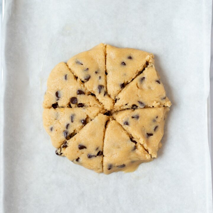Shaped scone dough that has been cut into 8 wedges.