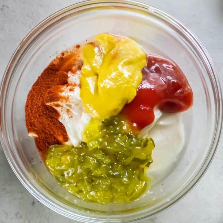 Glass bowl with the ingredients for making a big mac sauce.