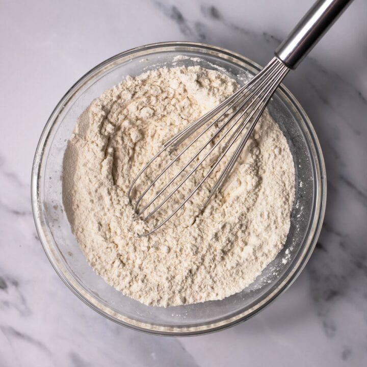 Glass bowl with whisked dry cake ingredients.