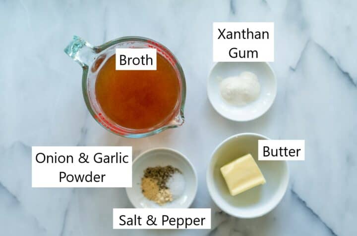 Measuring cup with broth and 3 small white dishes. 1 with butter, 1 with seasonings, and 1 with xanthan gum.