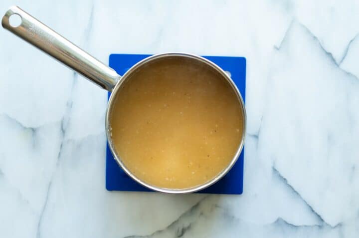 Silver pot containing cooked keto gravy