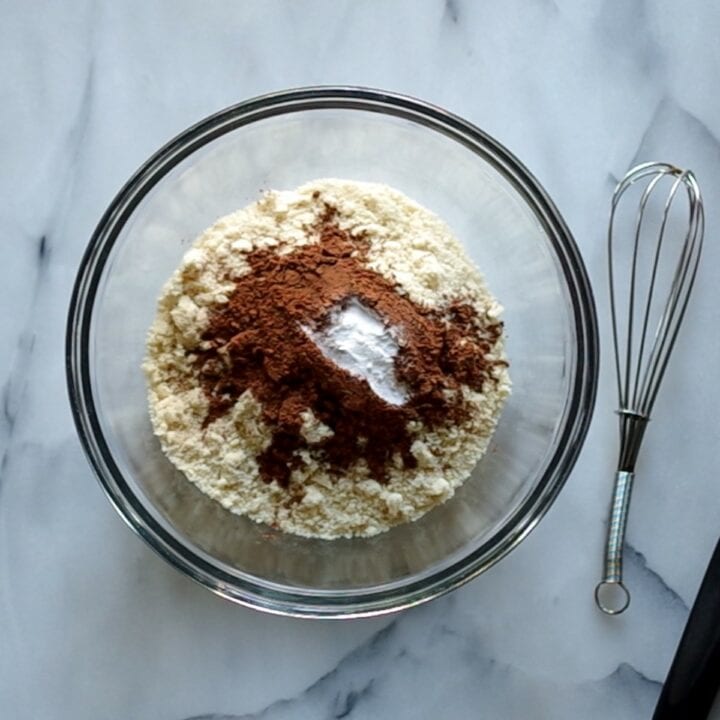 Glass bowl with the dry ingredients needed to make keto muffins.