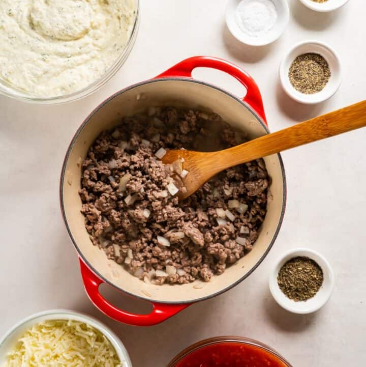 Saucepan with beef, onion and garlic being cooked.